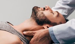 man receiving chiropractic service after learning about back to you chiropractor